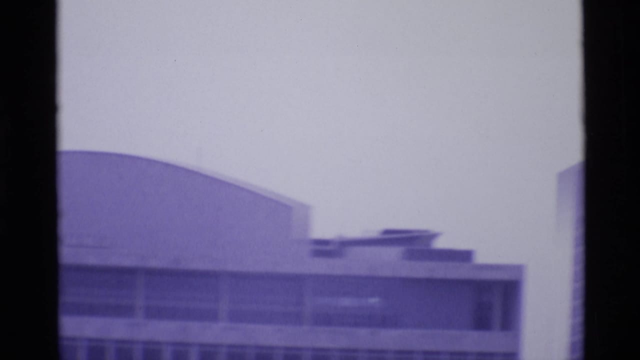 1969 London frame with the Royal Festival Hall area appearing as a broad curved roof and adjoining modernist facade.
