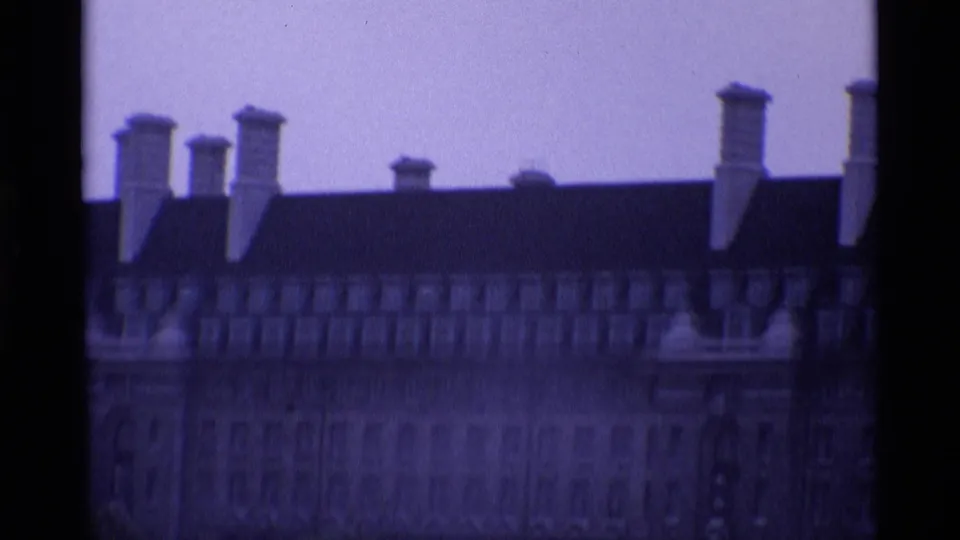 1969 London 8mm frame showing a soft close view of a roofline with repeated chimneys and muted building detail.