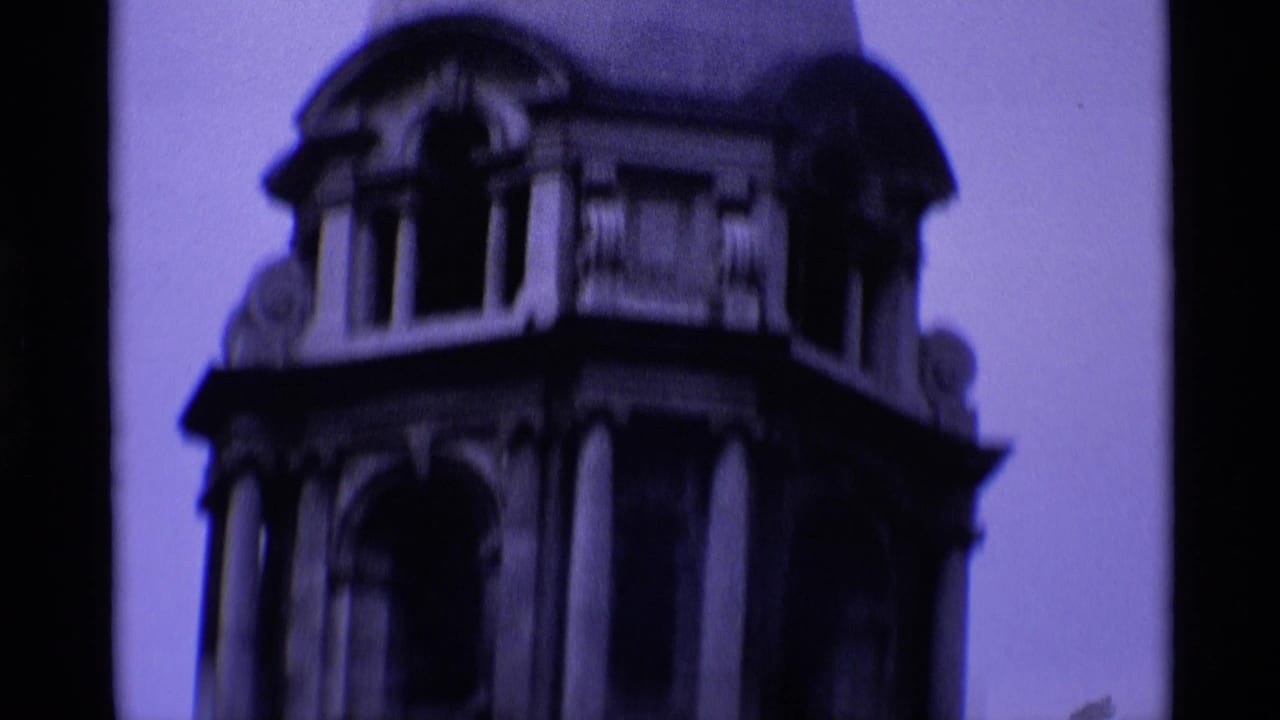 1969 London 8mm frame showing a soft, purple-tinted close view of an ornate domed stone tower and arched openings.
