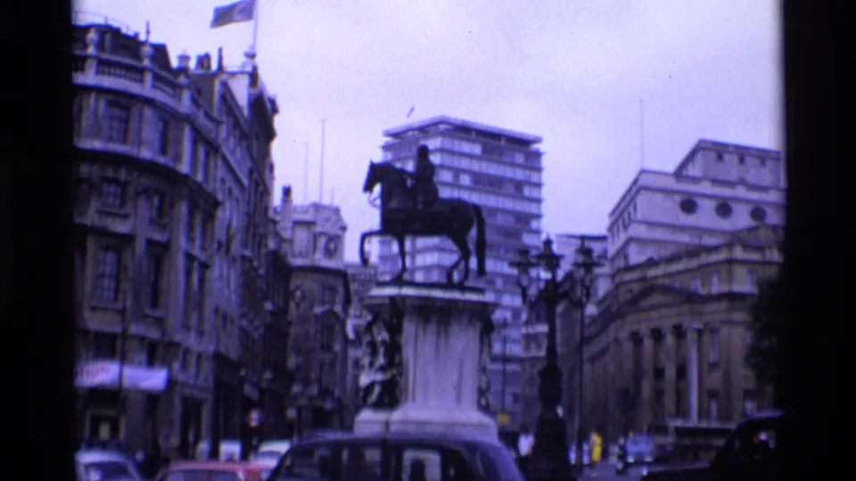 1969 London view of an equestrian statue framed by historic facades, traffic, and newer city buildings.