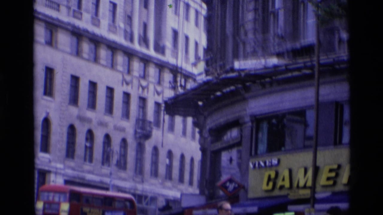 A 1969 London street view shows tall facades, a red double-decker bus, and a large camera-shop sign partly visible.