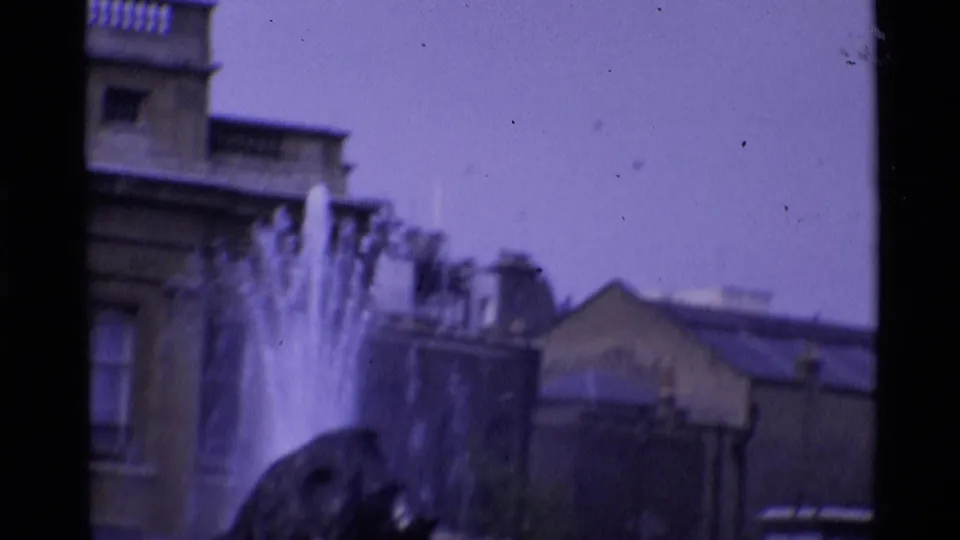 Soft 1969 London view of a fountain and surrounding stone architecture, filmed with a purple 8mm color cast.