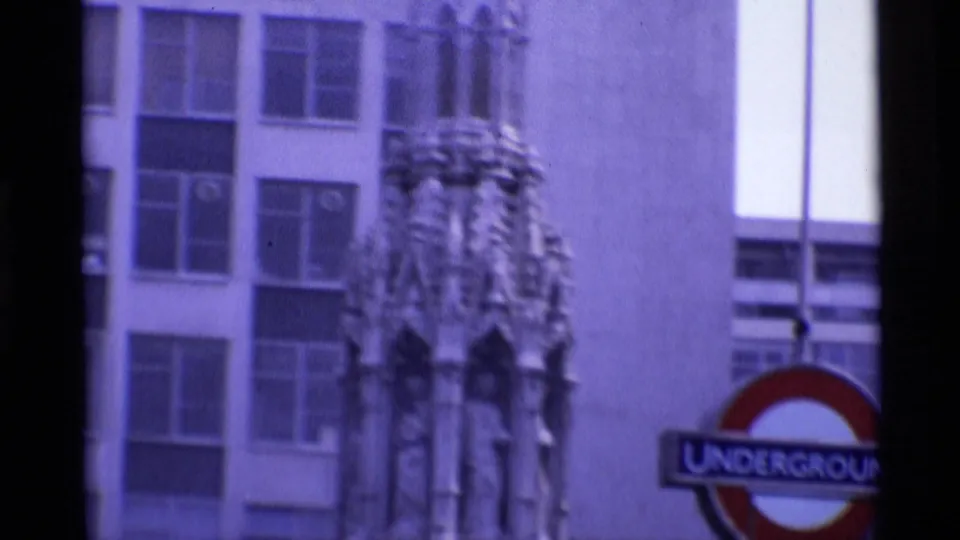 1969 London view of an ornate public monument detail with an Underground roundel and city building windows nearby.