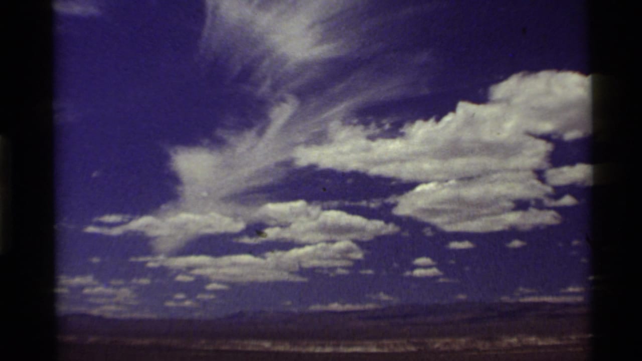 Large white clouds fill a blue sky above a distant horizon.