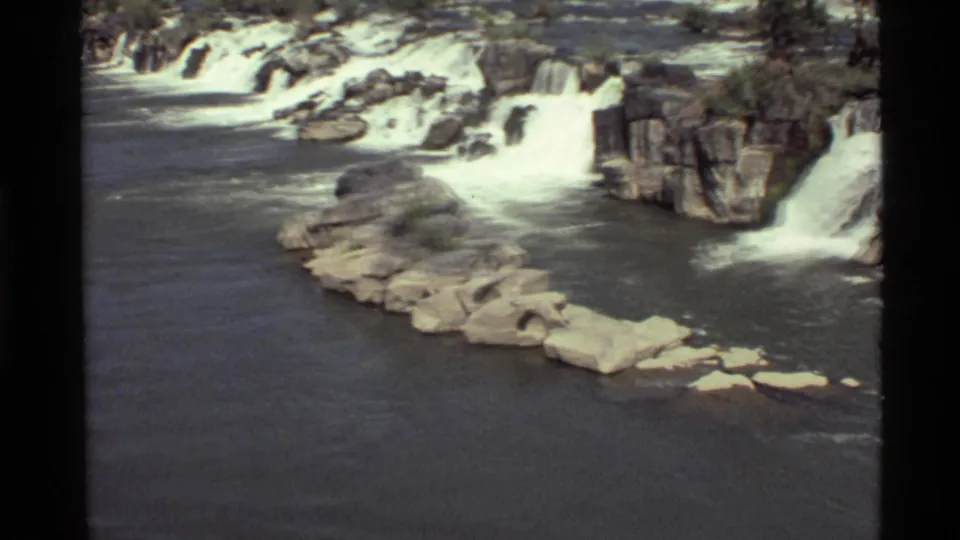 Holland Lake, Montana waterfall scene on 8mm film, showing white water dropping over rugged rock formations.
