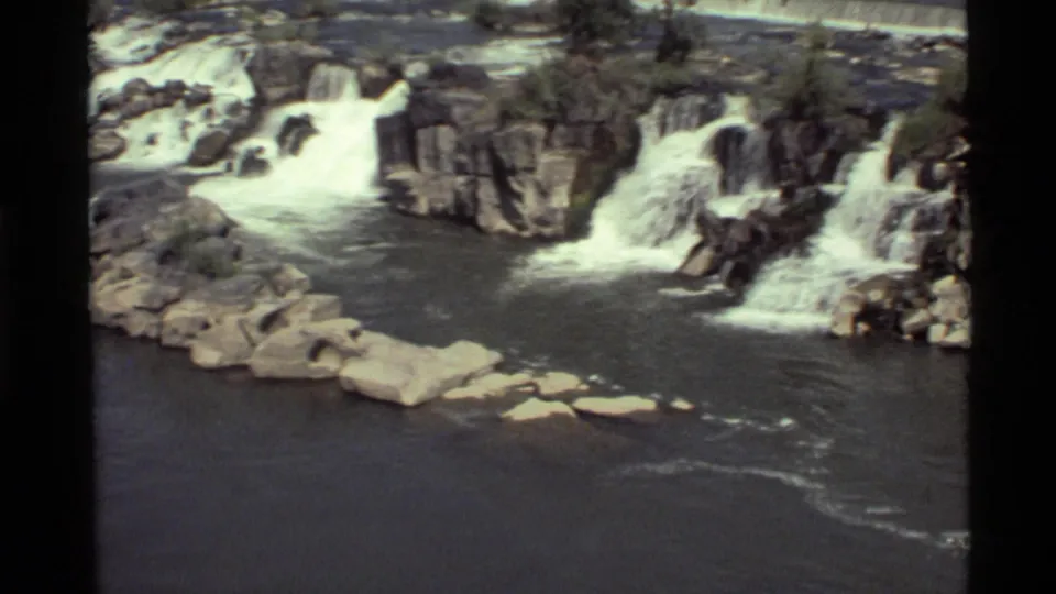 1972 Holland Lake, Montana 8mm frame with multiple rocky cascades and foaming water across the river channel.