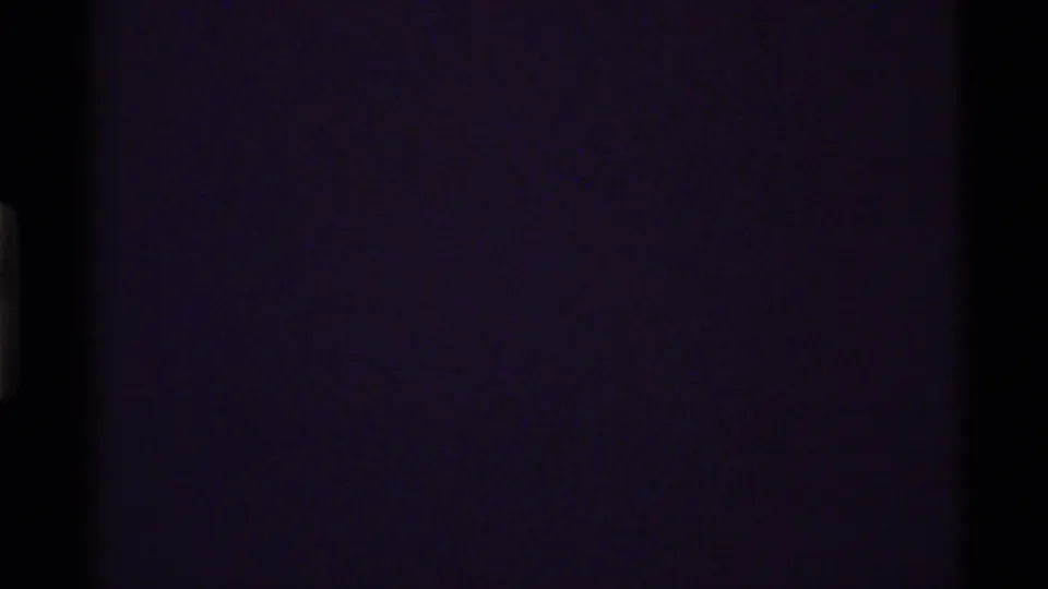 A dark 8mm end frame with faint purple coloration and no discernible landscape detail visible.