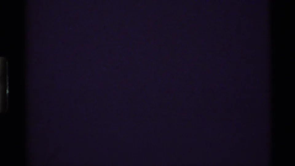 Opening 8mm frame from the 1972 Holland Lake clip, largely dark with only faint grain and edge exposure visible.