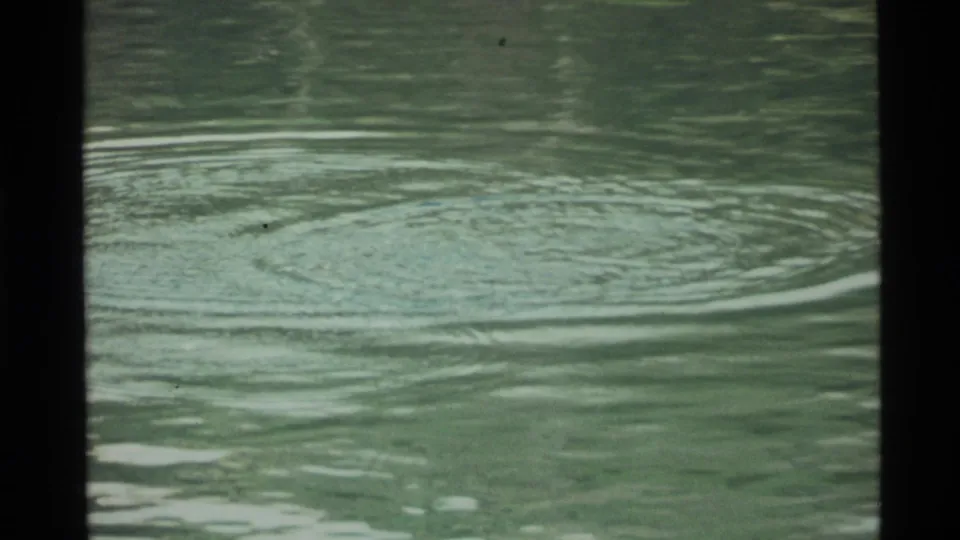 A broad set of rings spreads over Holland Lake water in the final still from the 1972 8mm clip.