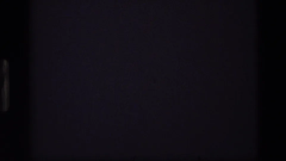Mostly dark 8mm frame area from the 1972 Idaho clip, with only faint film texture and edge shading visible.