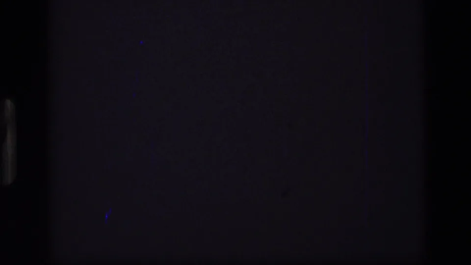 Dark opening 8mm frame from the 1972 Idaho clip, showing little detail beyond film edges and faint scan artifacts.