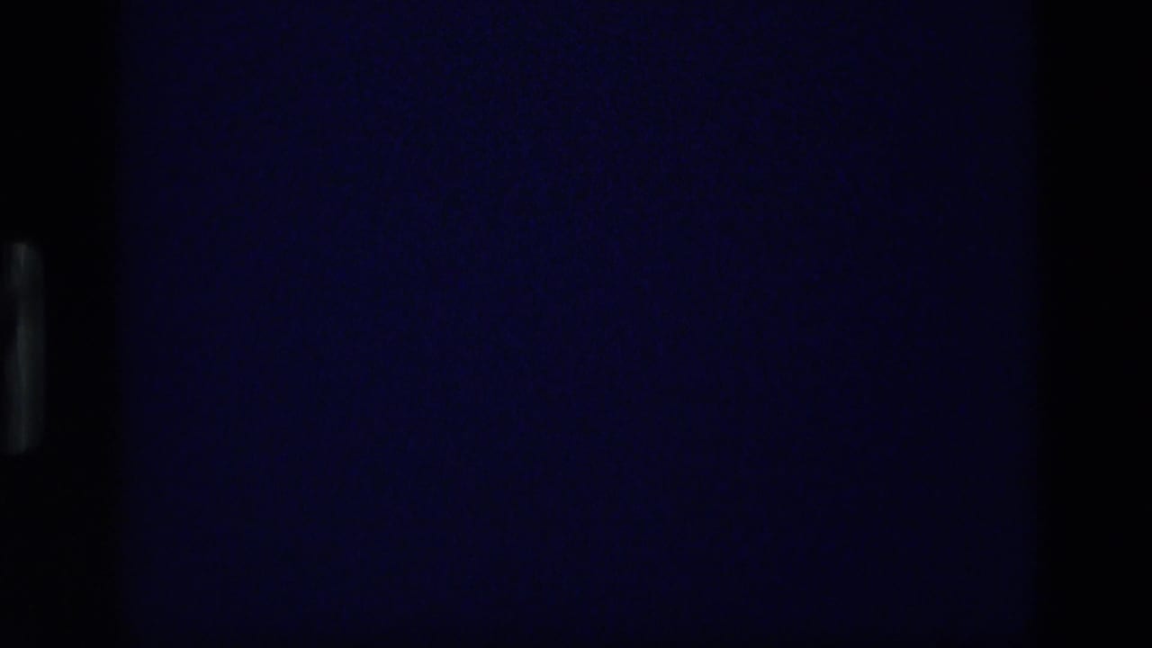 1972 Idaho 8mm frame showing a very dark storm-sky view with minimal visible horizon and strong projected-film borders.