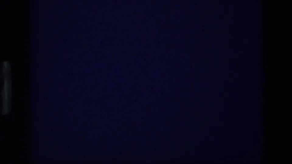 1972 Idaho 8mm frame showing a very dark storm-sky view with minimal visible horizon and strong projected-film borders.
