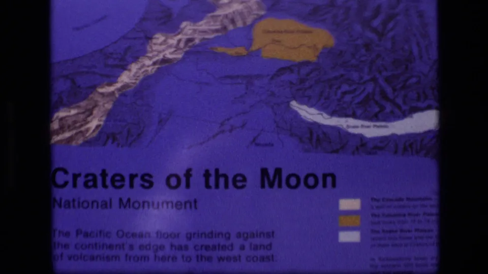 Second 1972 Idaho frame of the Craters of the Moon display, showing the sign title, map colors, and soft 8mm exposure.
