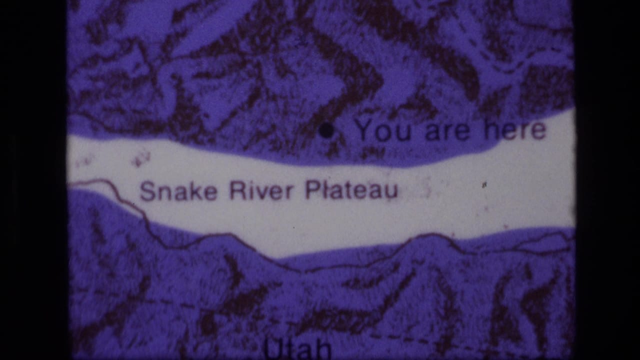 1972 8mm frame showing a purple-tinted Snake River Plateau map with a You are here marker and Idaho-Utah area labels.