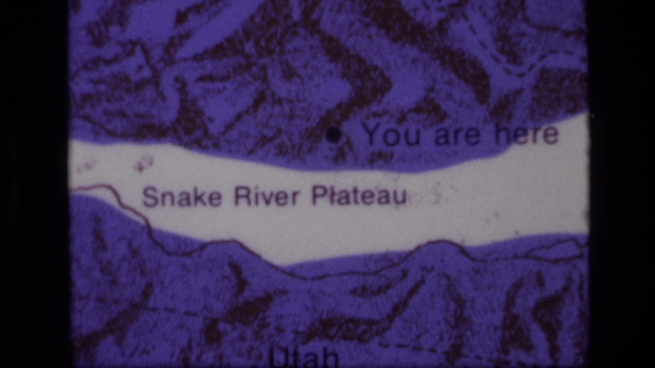 Close 8mm view of the Snake River Plateau map in Idaho, with a black location dot and strong purple color shift.