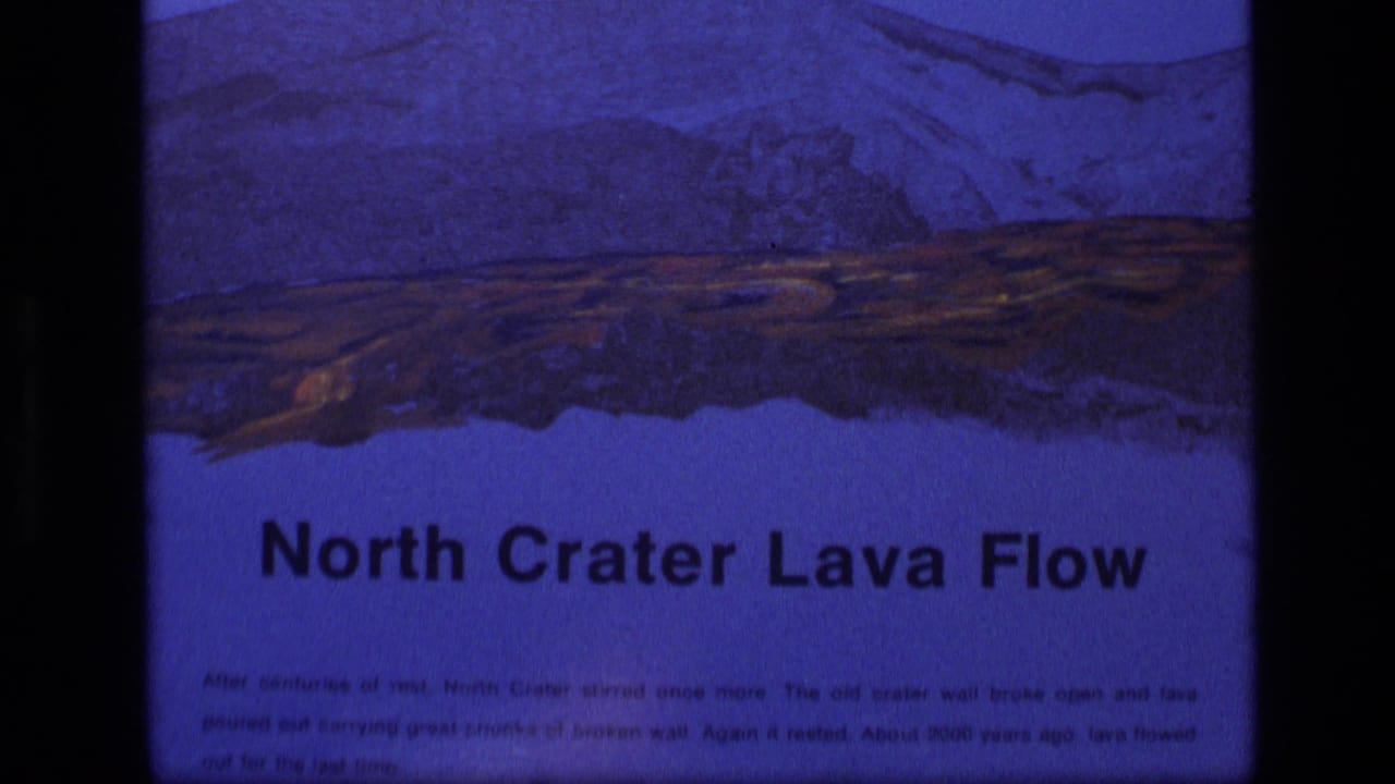 Interpretive sign reading North Crater Lava Flow with an illustrated lava landscape above it.