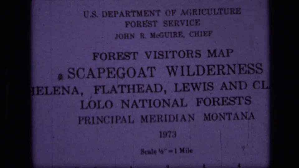 Close 8mm frame of the Scapegoat Wilderness Forest Visitors Map title page with 1973 date and scale text.