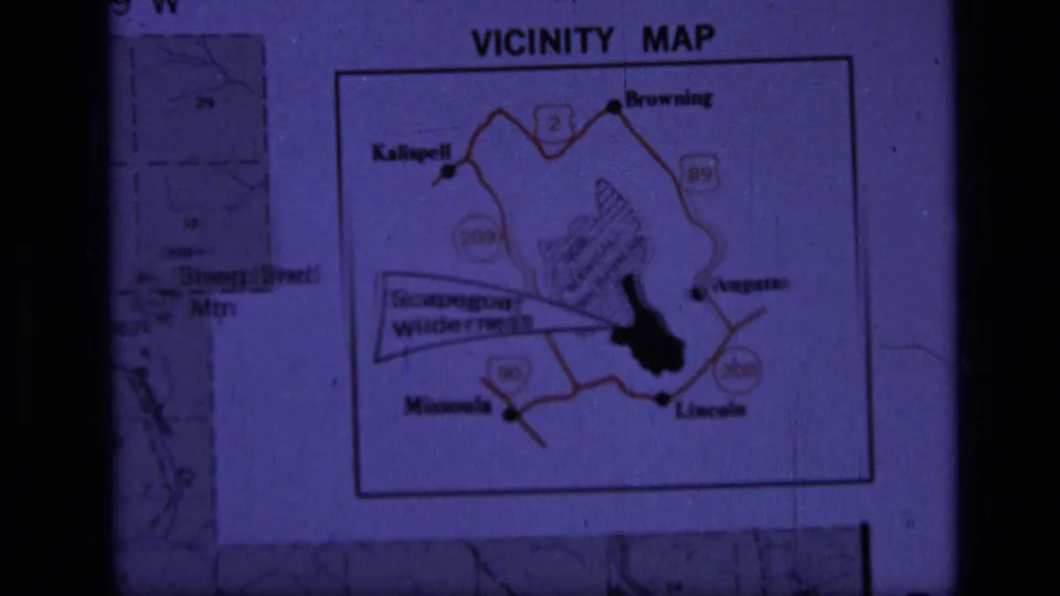 Projected 8mm frame of a Montana vicinity map centered on Scapegoat Wilderness and nearby road routes.
