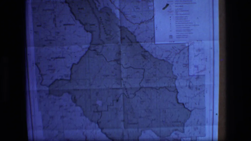Projected 8mm frame of the Scapegoat Wilderness, Montana map with visible boundaries, legend box, soft grain, and dark border edges.