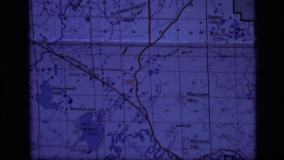 Blue-tinted Super 8 frame of a Montana topographic map with Browns Lake, Mineral Hill, grid lines, and route markings.