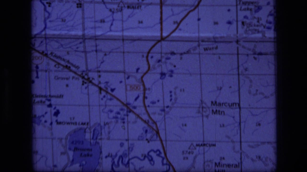 1973 8mm close-up of a Scapegoat Wilderness area topographic map showing Marcum Mountain, Browns Lake, and surrounding grid detail.