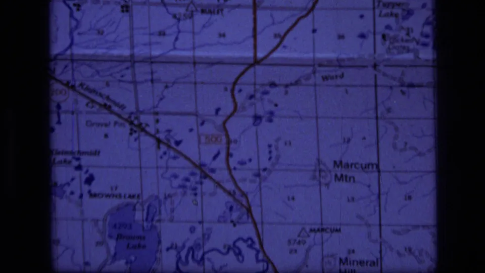 1973 8mm close-up of a Scapegoat Wilderness area topographic map showing Marcum Mountain, Browns Lake, and surrounding grid detail.