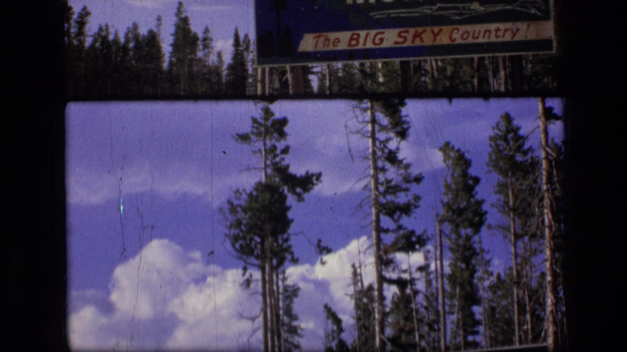 Big Sky Country sign partly visible above trees and clouds.