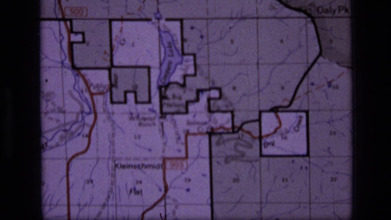 1973 8mm frame showing a Scapegoat Wilderness area topographic map with section grid, contour lines, bold boundaries, and labeled places.