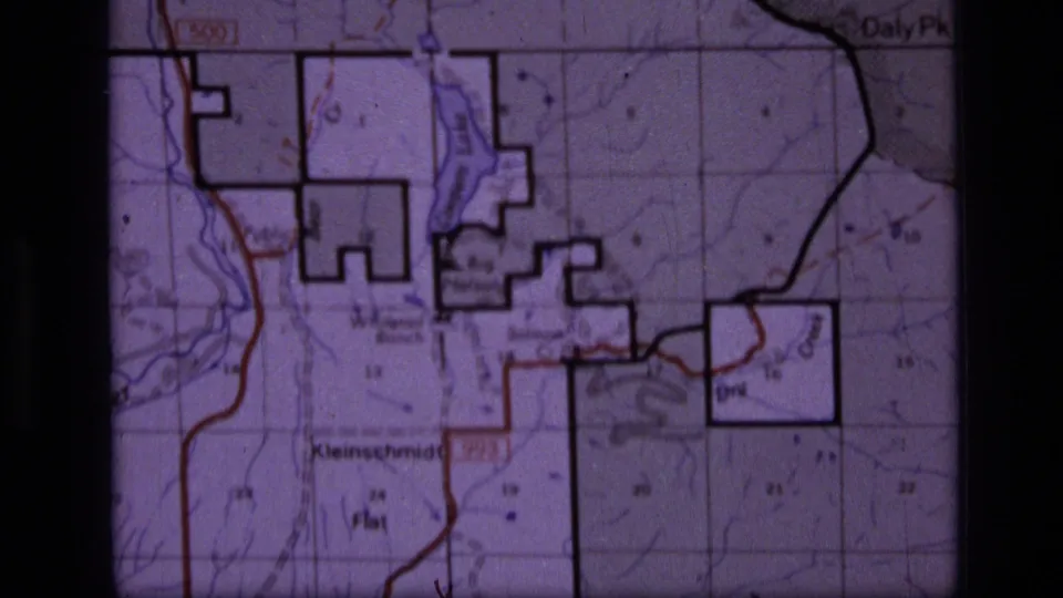 1973 8mm frame showing a Scapegoat Wilderness area topographic map with section grid, contour lines, bold boundaries, and labeled places.