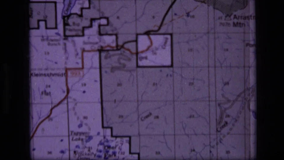 1973 8mm frame of a Scapegoat Wilderness topographic map, including Klein Schmidt Flat labeling, boundary shapes, and route markings.