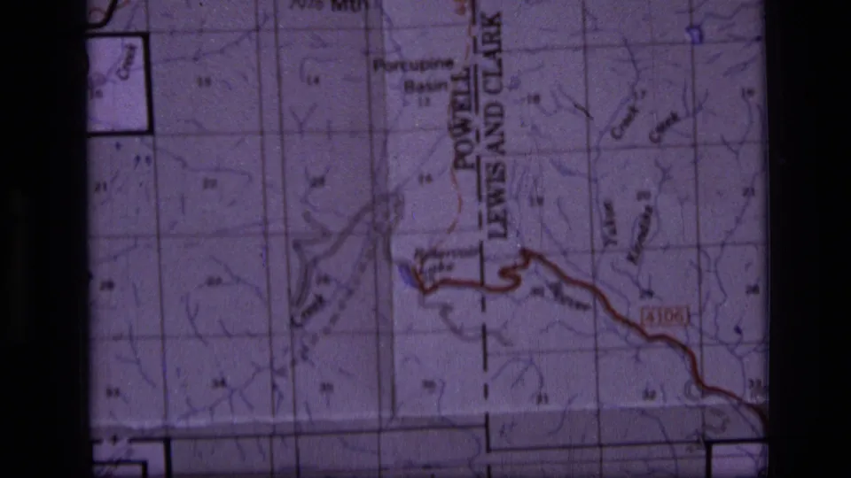 Close 1973 wilderness map frame showing basin and creek labels, contour detail, grid sections, and a red boundary or route line.