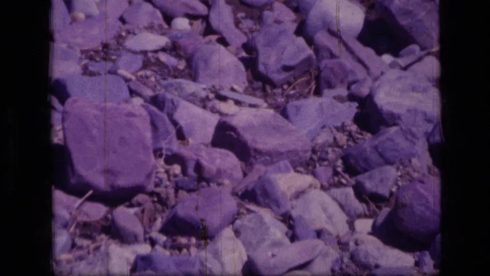 Rocky ground in Scapegoat Wilderness, Montana, seen in aged 8mm color with no face or landmark visible.