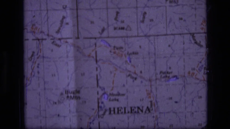 Second close view of the paper map around Helena, with grid lines, lake names, and route markings visible in faded 8mm color.
