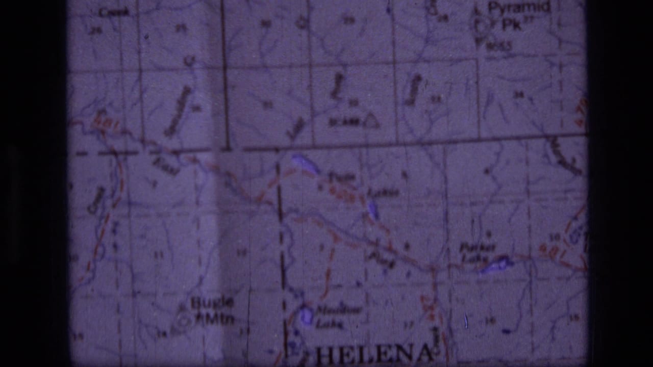 1973 8mm frame showing a close-up of a Helena, Montana area topographic map with Bugle Mtn and Pyramid Peak labels visible.