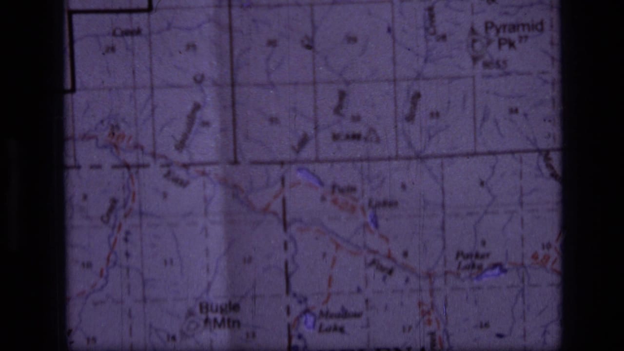 Close 8mm view of a Montana topographic map, with Helena-area labels and colored terrain or route markings visible.