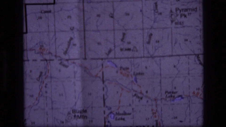 Close 8mm view of a Montana topographic map, with Helena-area labels and colored terrain or route markings visible.