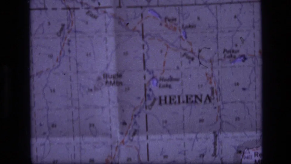 Close view of a printed Montana map with Helena visible, used as a travel reference in the 1973 home-movie sequence.
