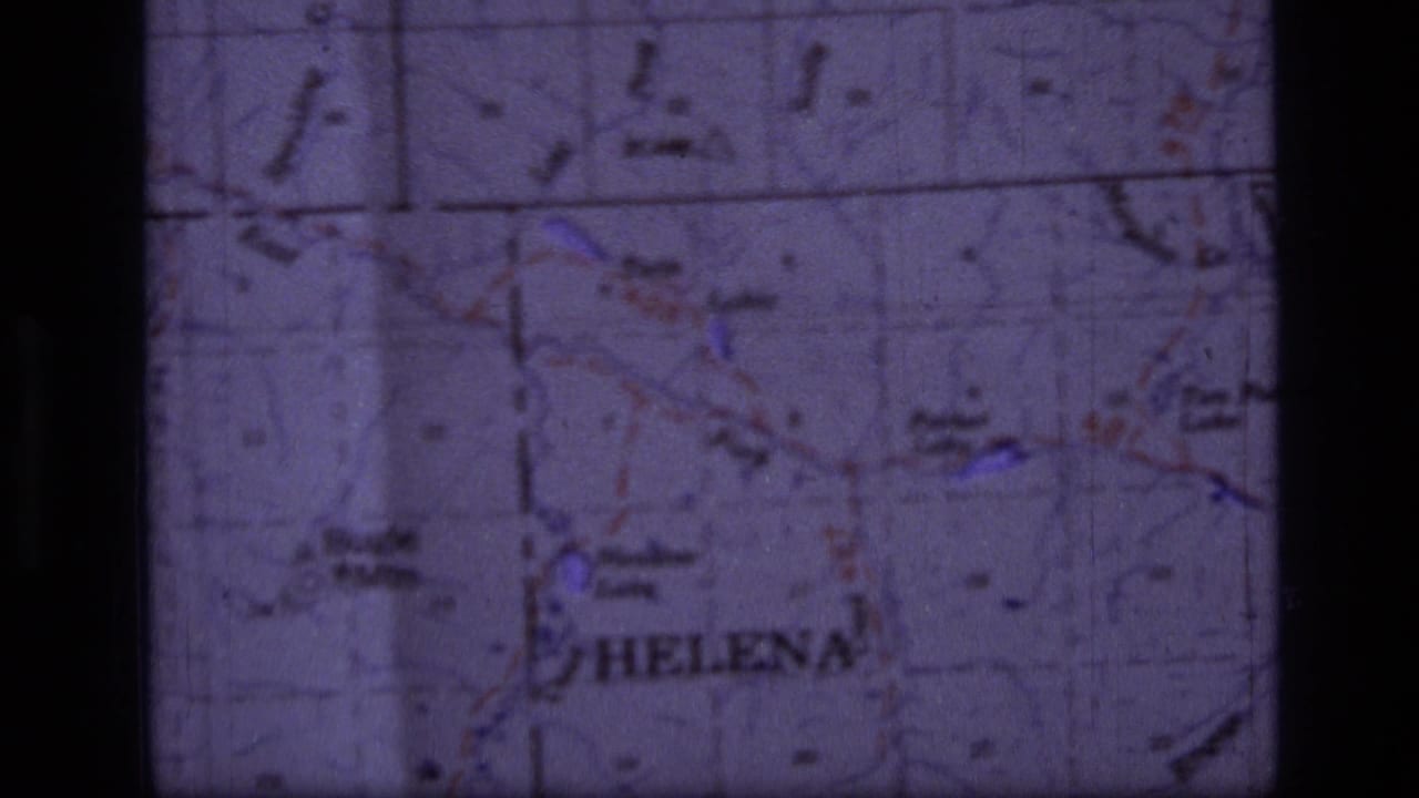 1973 8mm close-up of a Montana-area topographic map with Helena legible and grid lines crossing the frame.