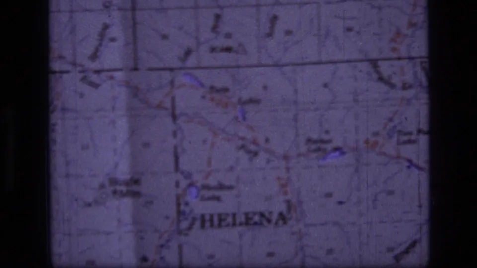 1973 8mm close-up of a Montana-area topographic map with Helena legible and grid lines crossing the frame.