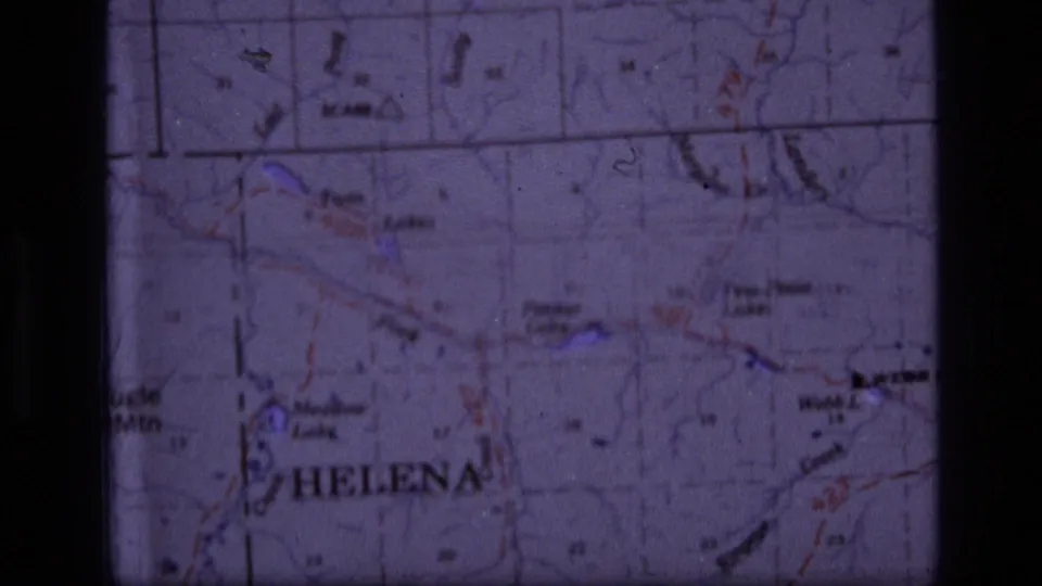 1973 8mm map view showing Helena and surrounding Montana map detail, partly divided by a dark film-frame border.