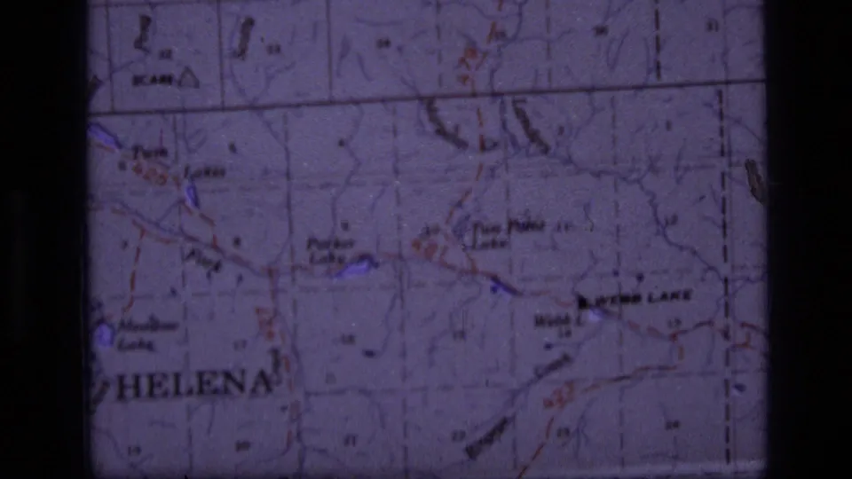 1973 8mm frame of the Scapegoat Wilderness area map, with Helena and Parker Lake labels visible through a purple cast.