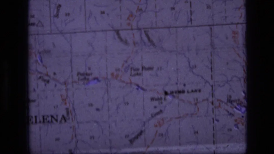 1973 8mm frame showing a Scapegoat Wilderness, Montana topographic map with Webb Lake, Heart Lake, trails, and grid lines.