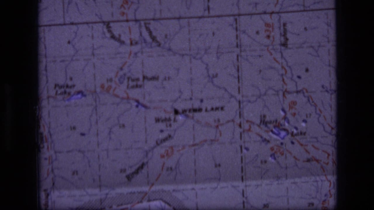 1973 8mm view of the Scapegoat Wilderness map area, showing Webb Lake, nearby trails, contour markings, and film gate shadow.