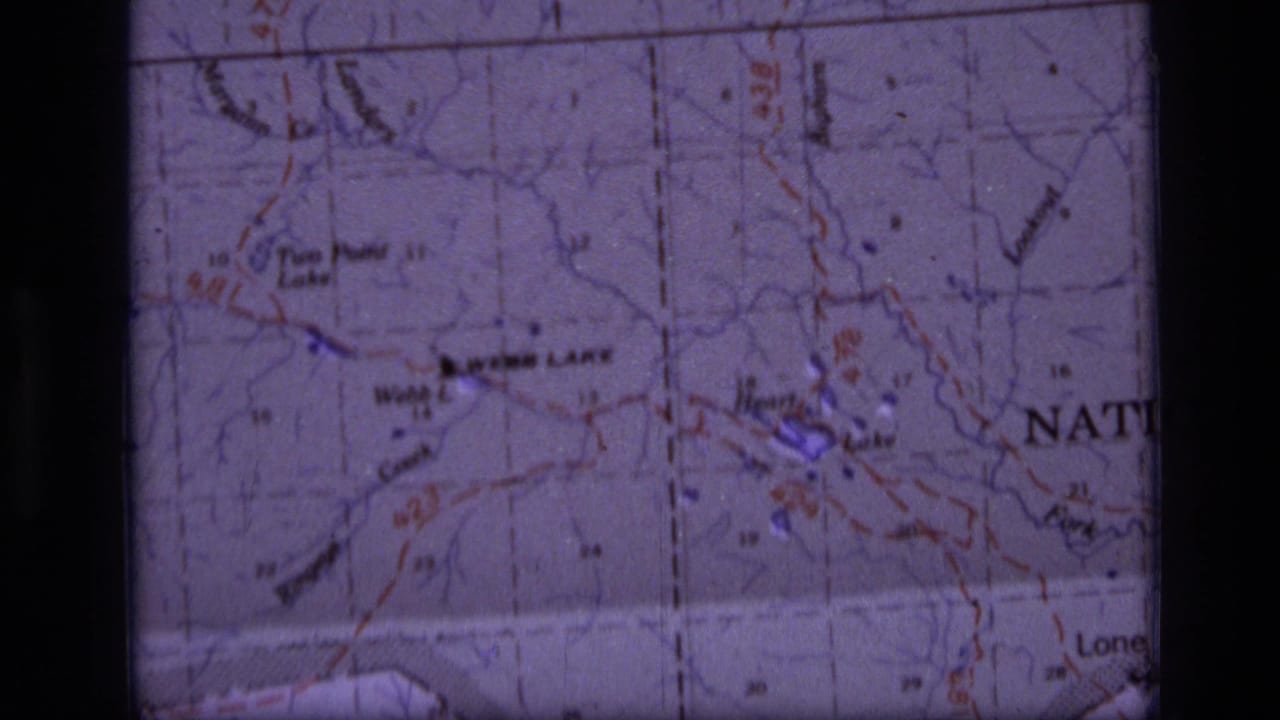 Topographic map detail with lake labels, grid lines, and dark film borders.