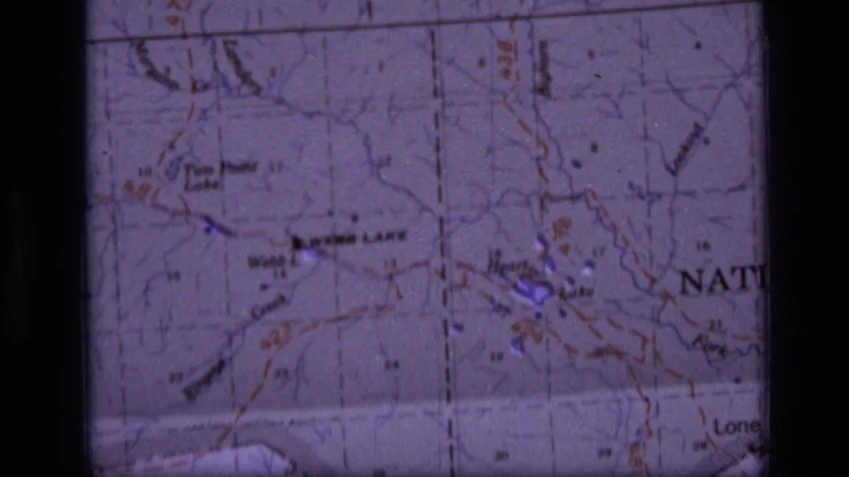 Scapegoat Wilderness map detail on 8mm film, with Webb Lake and Heart Lake labels, printed contour lines, and purple color cast.
