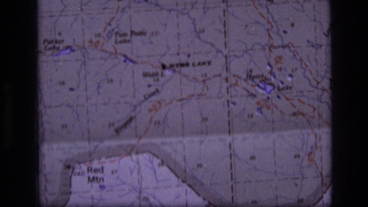 Close view of a topographic map with Webb Lake, Red Mtn, grid lines, and dark film borders.