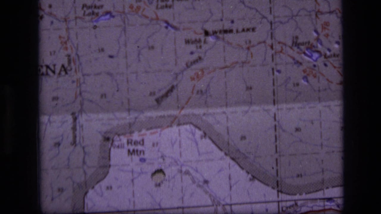 Close-up from the 1973 Montana map footage showing Red Mtn, printed terrain markings, and a dark 8mm frame edge.