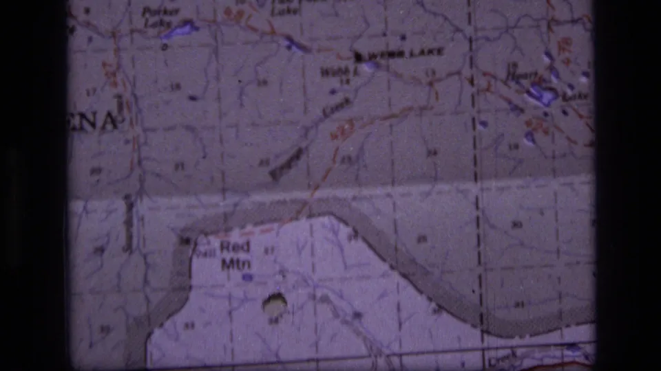 Close-up from the 1973 Montana map footage showing Red Mtn, printed terrain markings, and a dark 8mm frame edge.