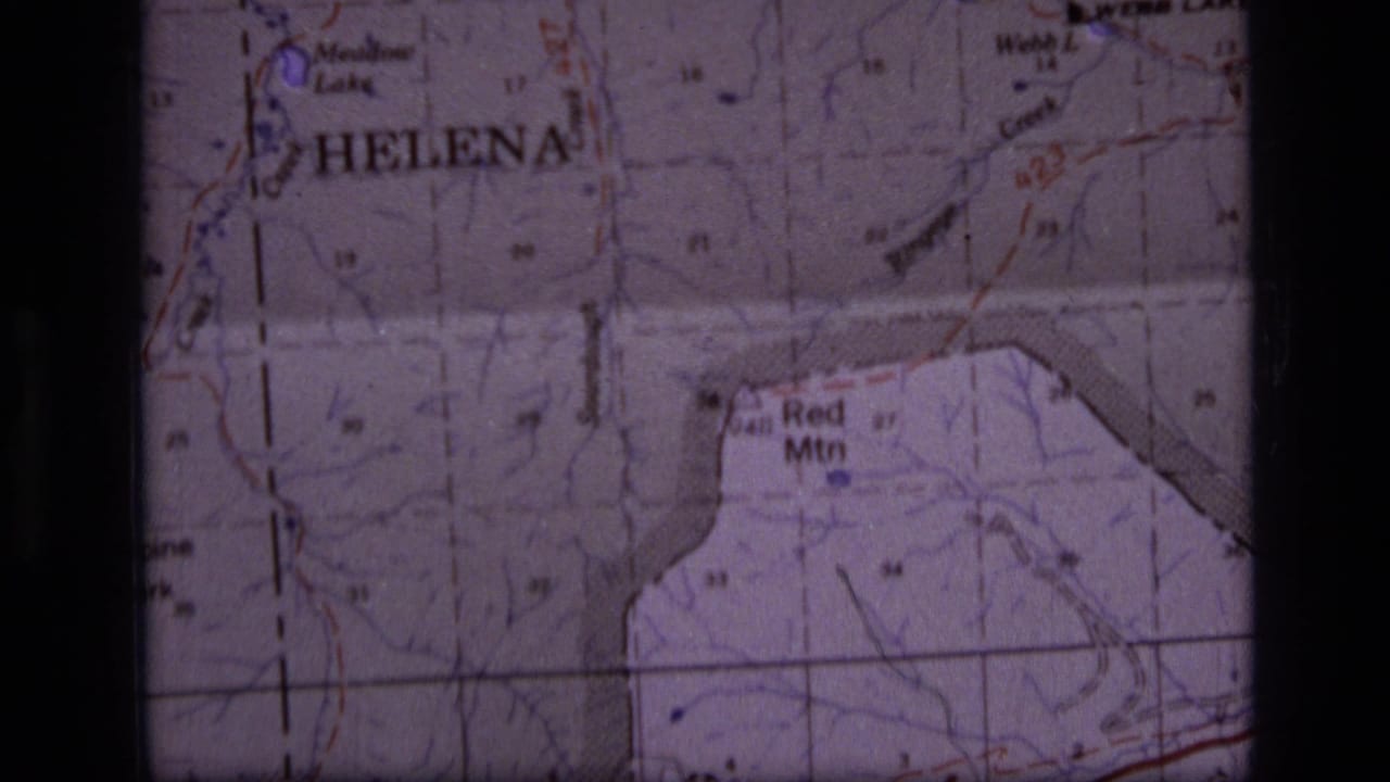 1973 8mm close-up of a Montana topographic map with Helena, Red Mtn, Webb Lake, grid lines, and soft film borders visible.